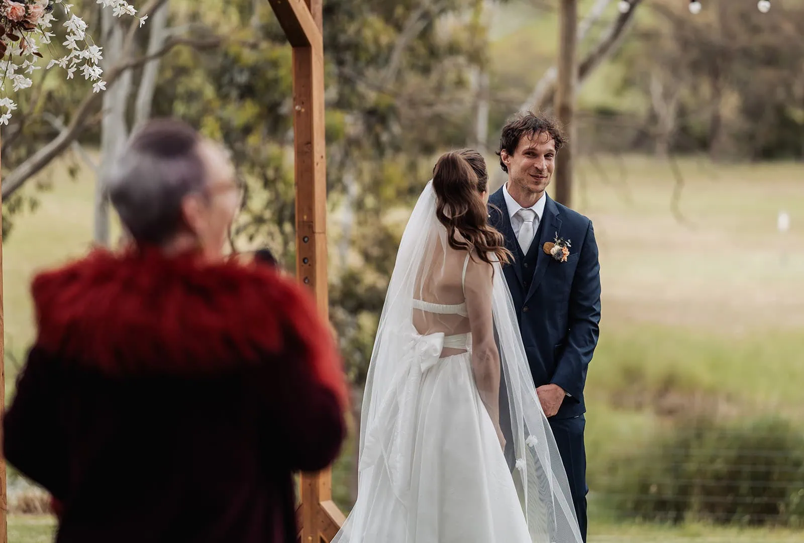 fleurieu cherries wedding - kimberley & richard 15 Elegant outdoor wedding scene with greenery, white flowers, and picturesque backdrop.