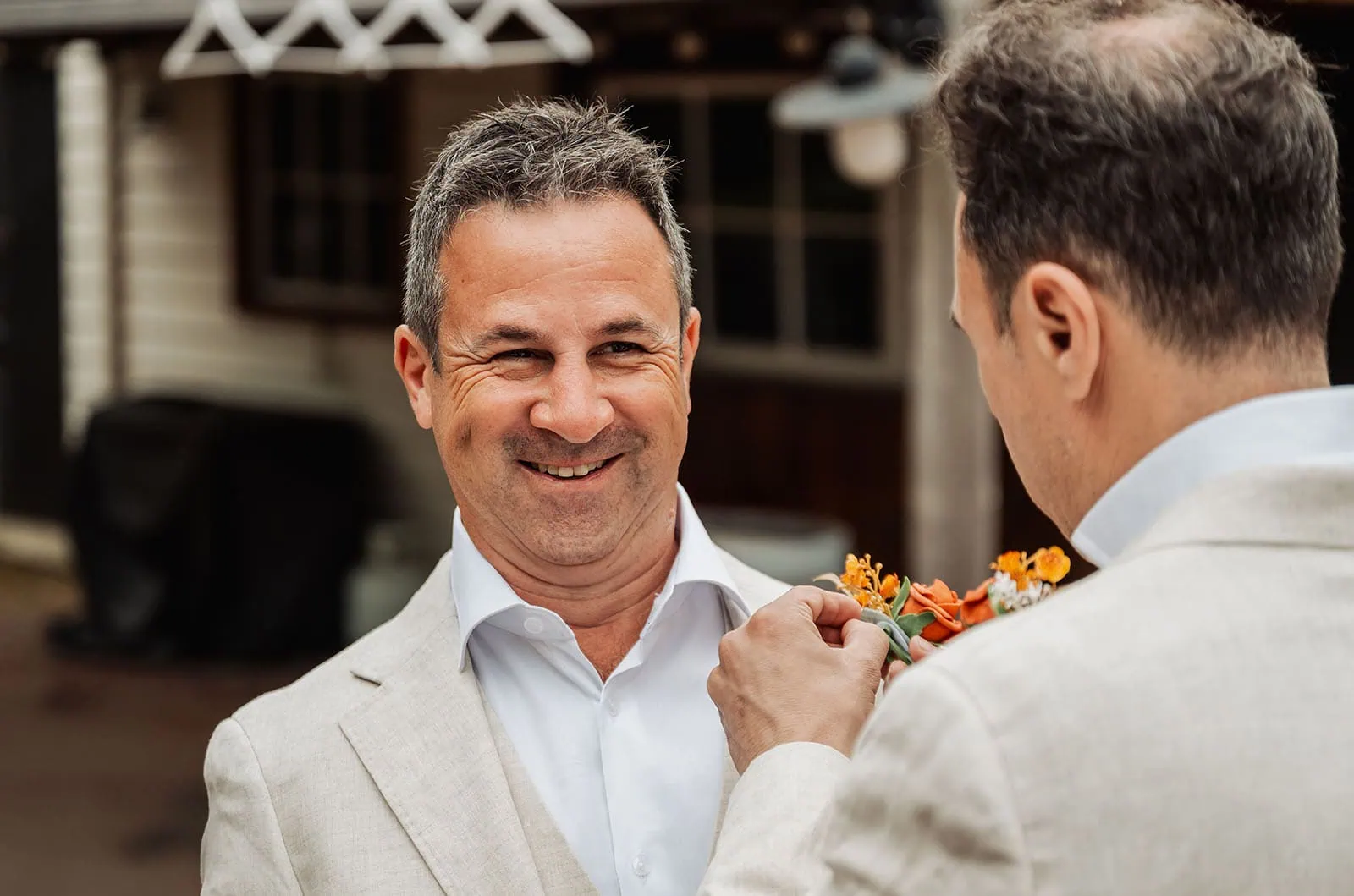 country victoria wedding in corrunnun – rachelle & anthony 287 Men smiling in suits, wearing boutonnieres at a formal event.