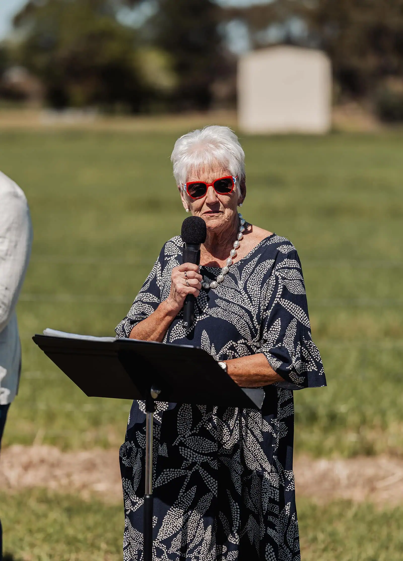 country victoria wedding in corrunnun – rachelle & anthony 321 Elderly woman speaking in blue dress, senior communication, public speech.