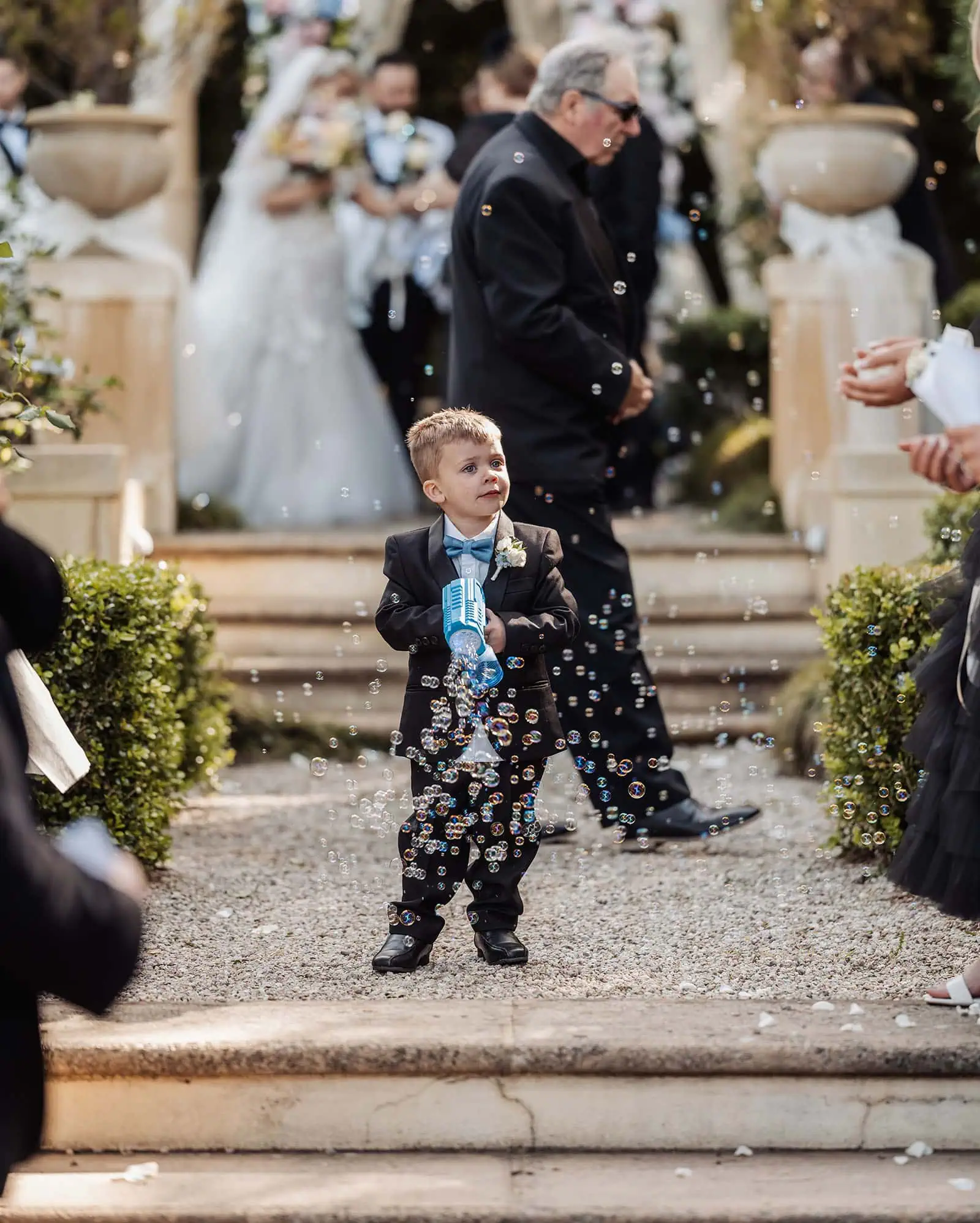 silvestris of clarendon wedding - sam & wayne 226 Boy blowing bubbles at wedding celebration.