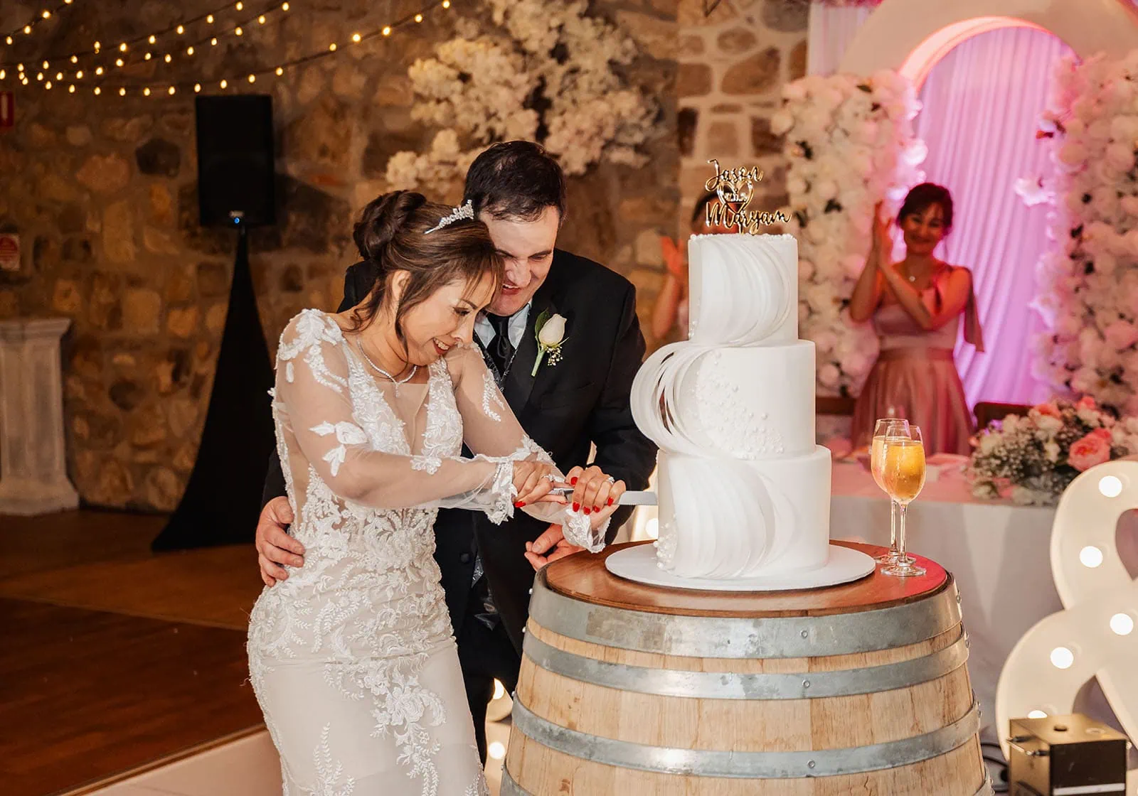wedding at the manor in basket range - maryam & jason 165 Bride and groom cut elegant wedding cake during reception ceremony.