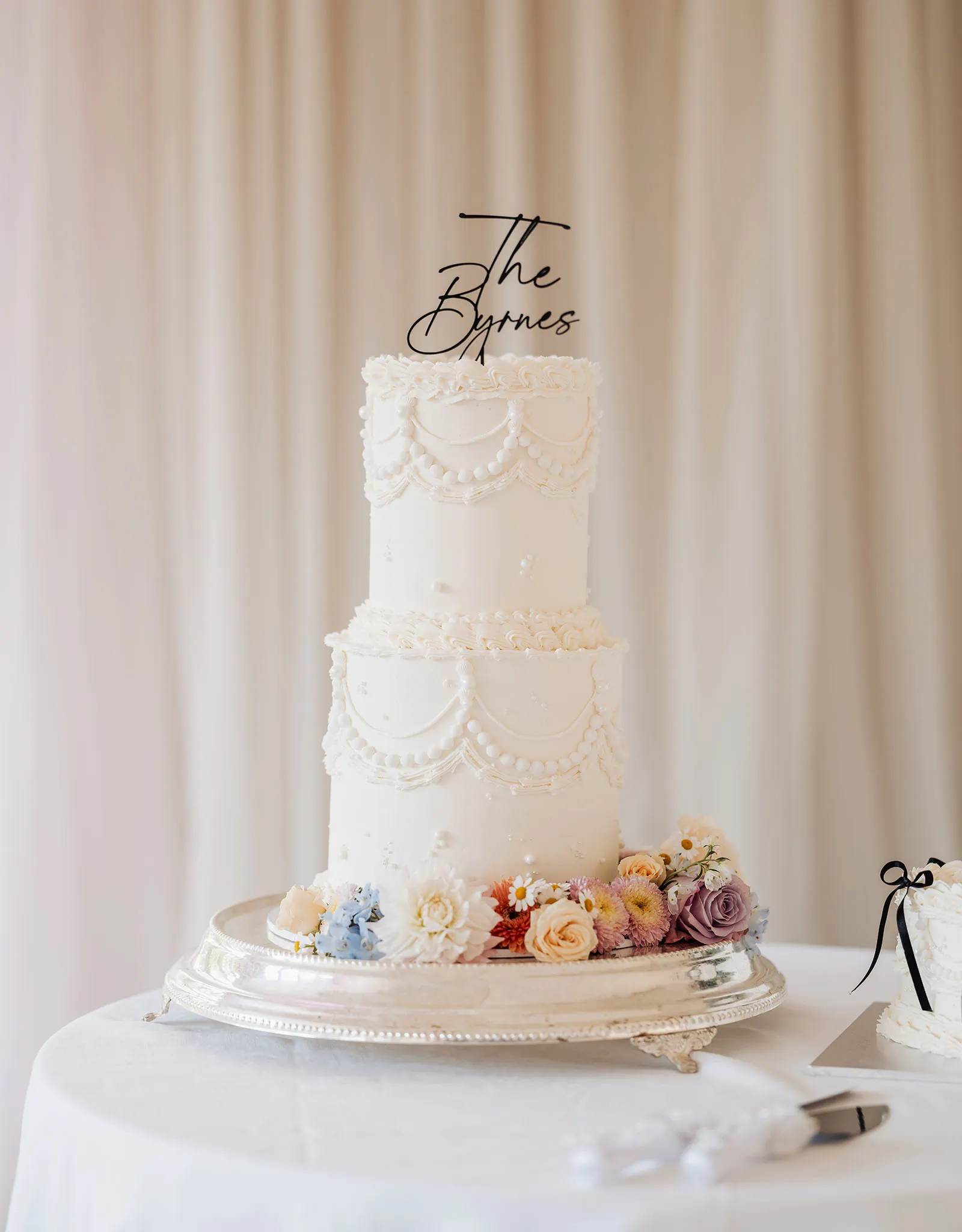 silvestris of clarendon wedding - sam & wayne 250 Elegant white wedding cake adorned with pearl decorations.