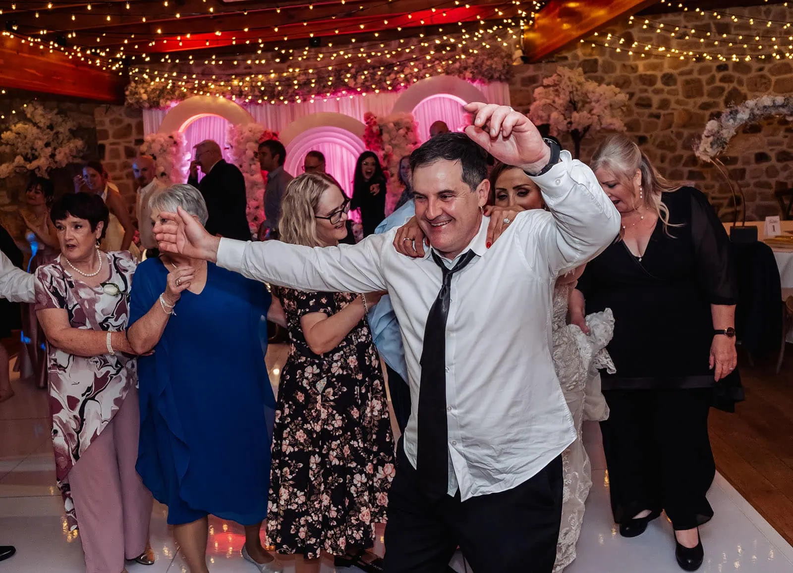 wedding at the manor in basket range - maryam & jason 176 A joyful couple dancing at a lively wedding celebration.