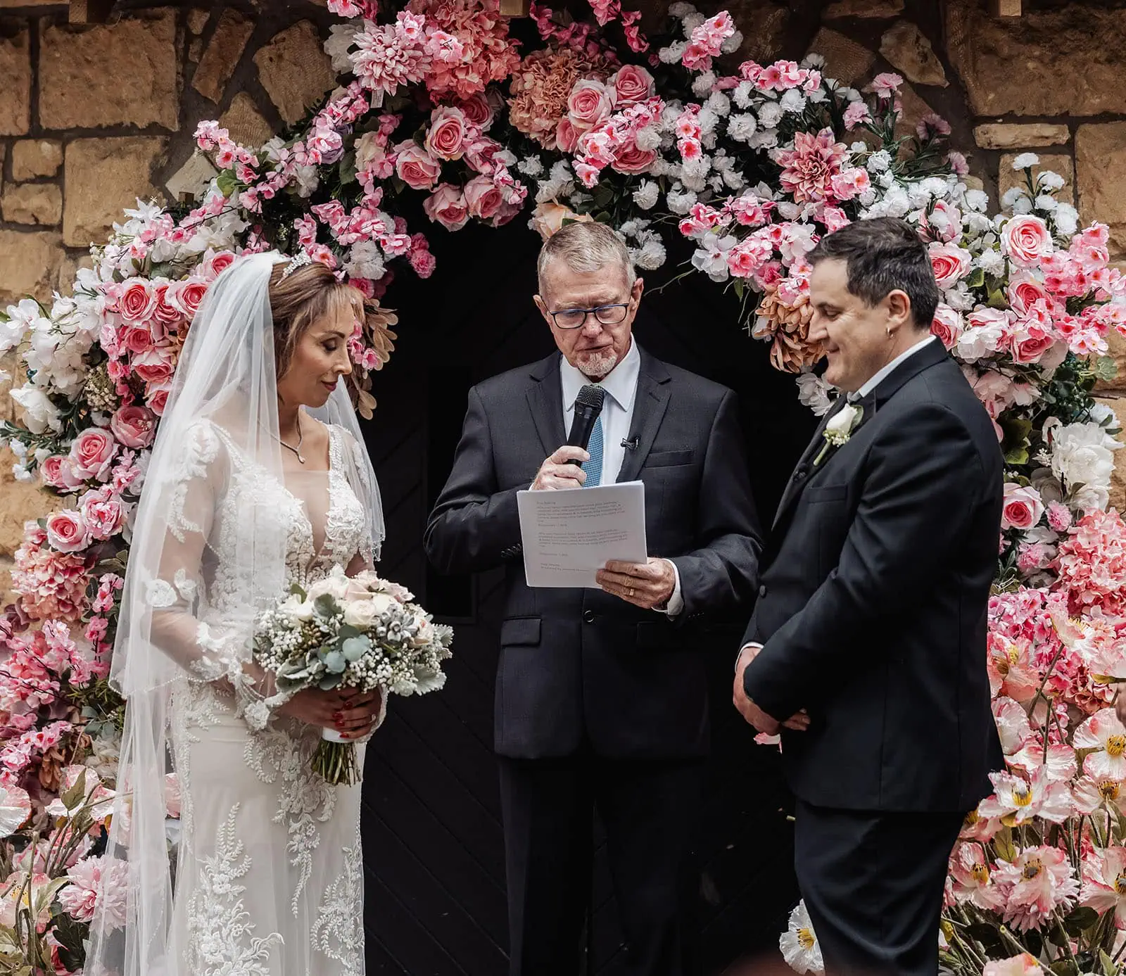 wedding at the manor in basket range - maryam & jason 134 Elegant floral arch at outdoor wedding ceremony.
