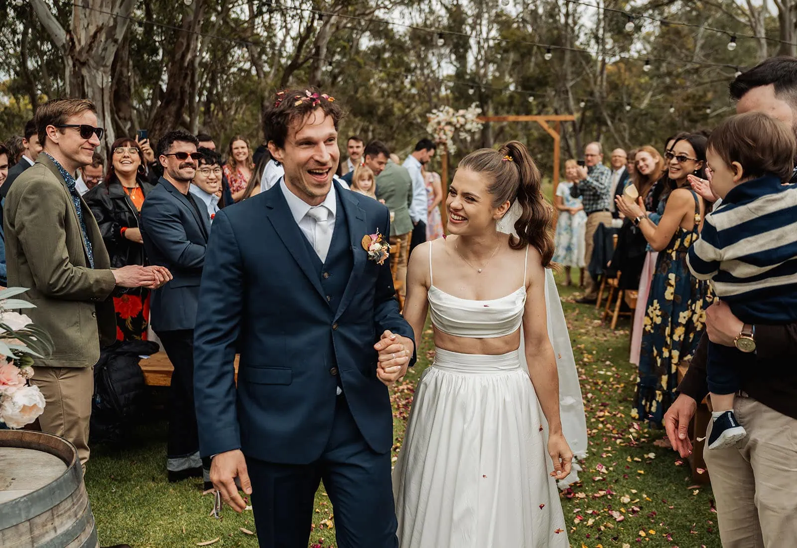 fleurieu cherries wedding - kimberley & richard 22 Bride and groom celebrating with family at elegant outdoor wedding ceremony.