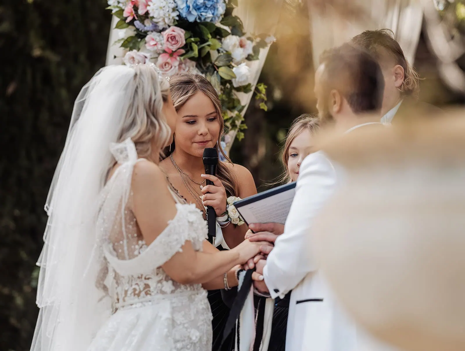 silvestris of clarendon wedding - sam & wayne 222 Elegant outdoor wedding ceremony with floral decorations and guests in attendance.