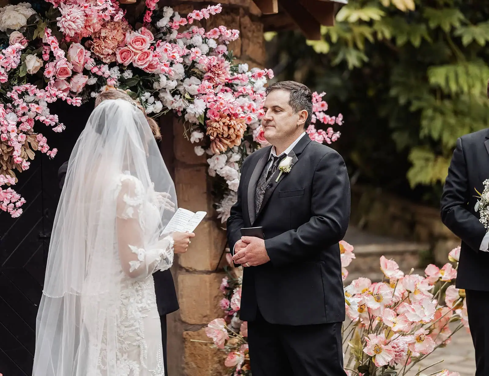 wedding at the manor in basket range - maryam & jason 137 Outdoor Wedding Ceremony with Lush Greenery and Elegant Floral Arrangements.
