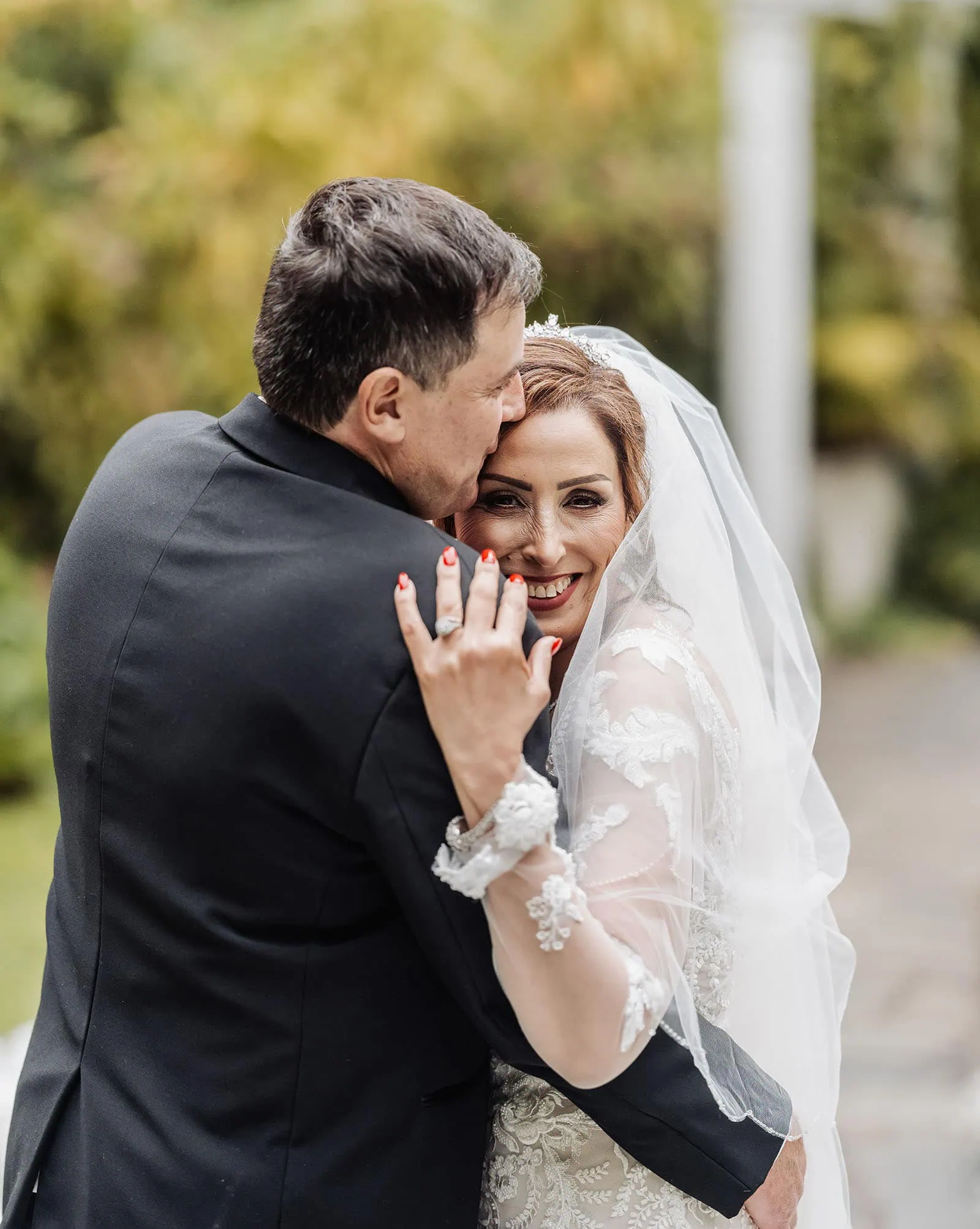 wedding at the manor in basket range - maryam & jason 154 Bride and groom share intimate embrace outdoors on wedding day.