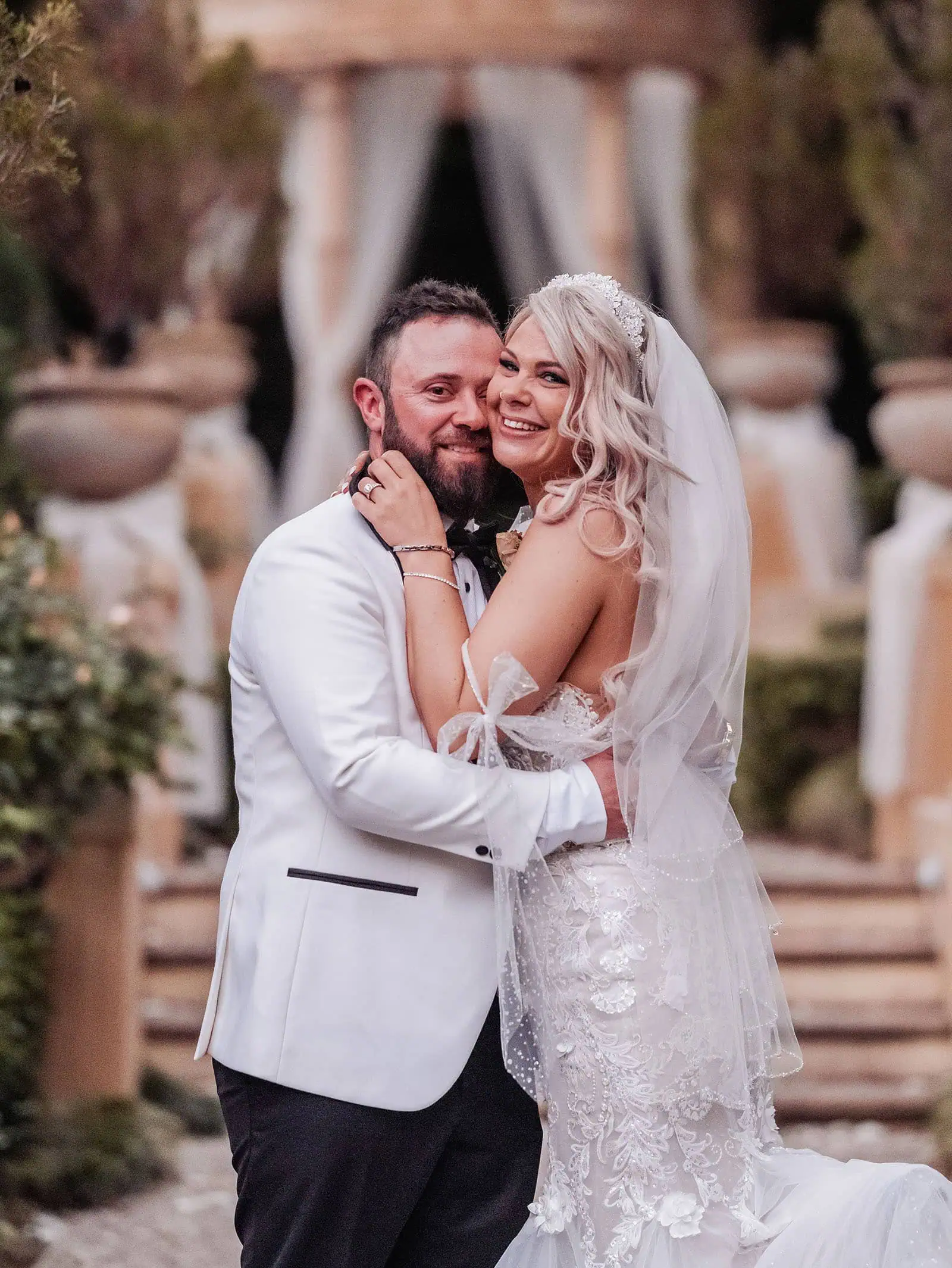 silvestris of clarendon wedding - sam & wayne 246 Bride and groom embracing lovingly in wedding attire.