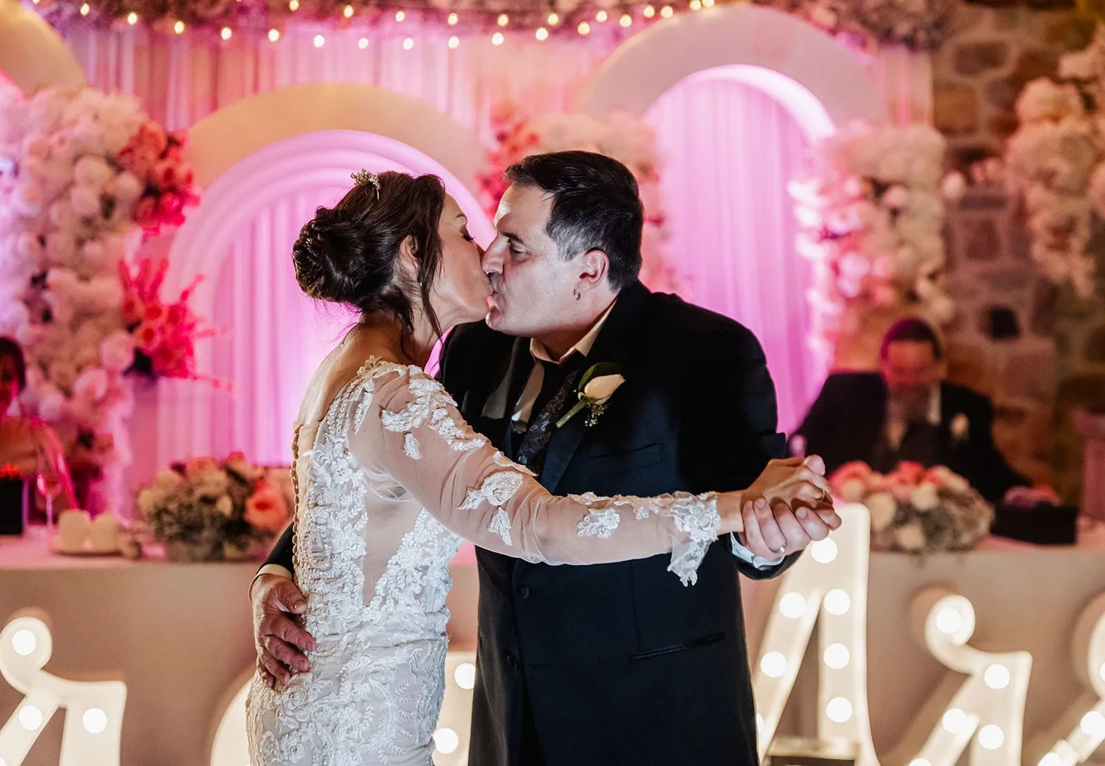 wedding at the manor in basket range - maryam & jason 169 Bride and groom share romantic first dance at elegant wedding reception.