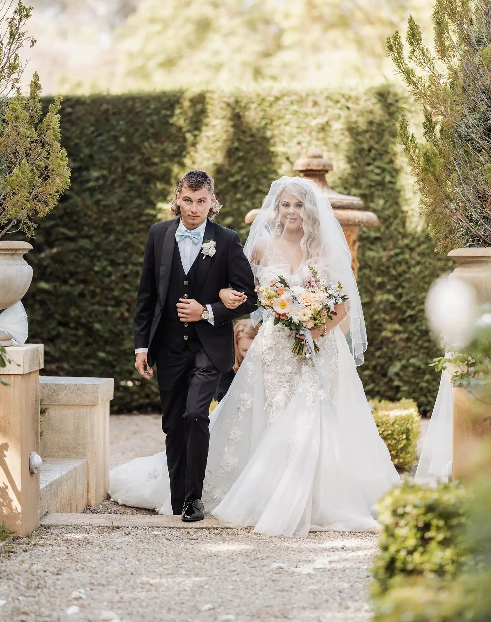 silvestris of clarendon wedding - sam & wayne 212 Garden wedding ceremony with elegant floral decorations and guests.