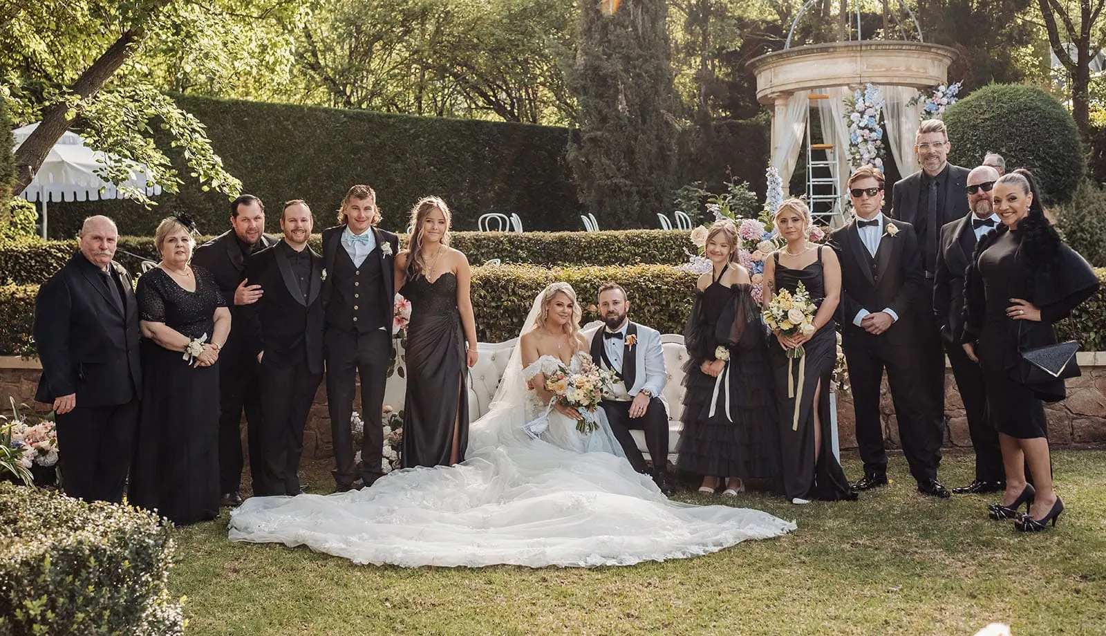 silvestris of clarendon wedding - sam & wayne 232 Outdoor wedding group photo with smiling guests and beautiful natural backdrop.