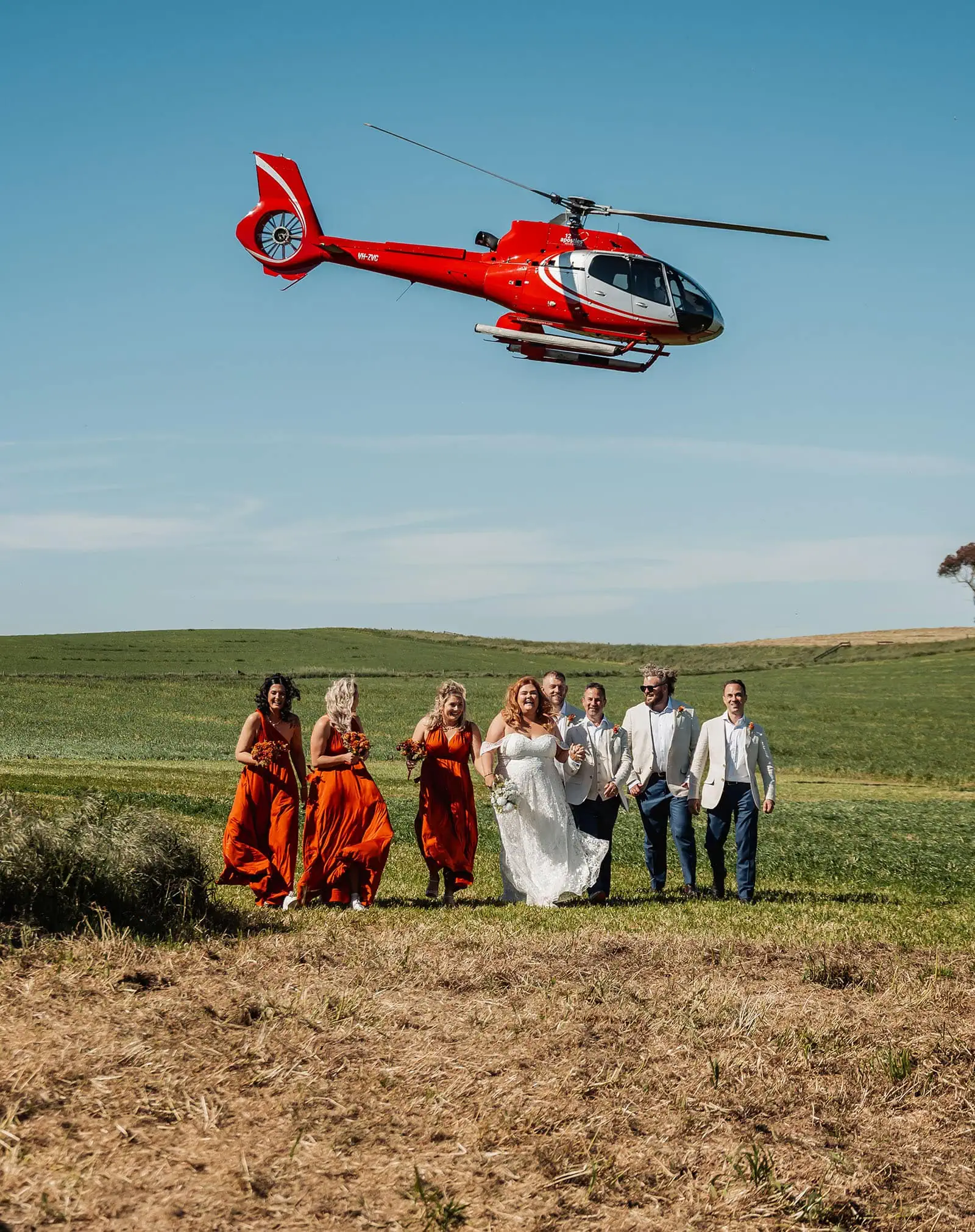 country victoria wedding in corrunnun – rachelle & anthony 335 Helicopter landing in field for scenic wedding ceremony backdrop.