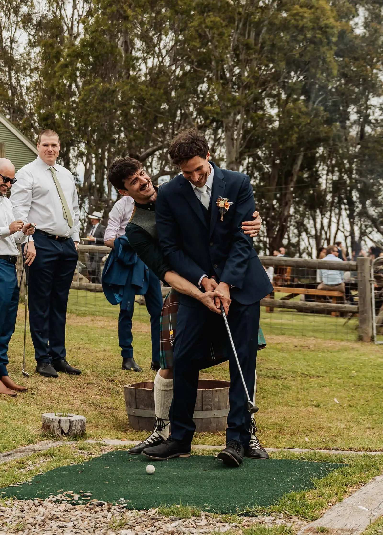 fleurieu cherries wedding - kimberley & richard 45 Guests enjoying a wedding-themed mini-golf game outside.