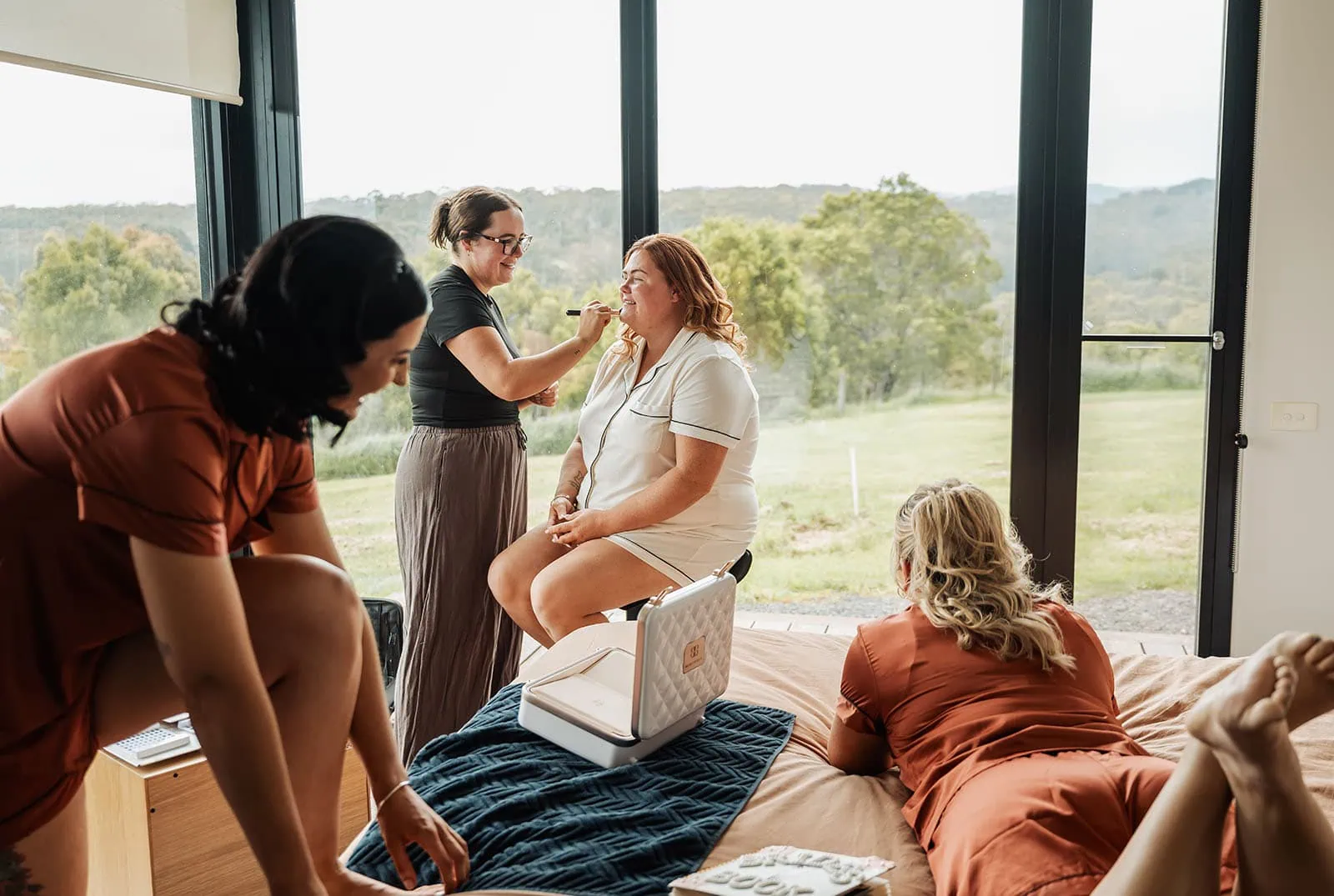 country victoria wedding in corrunnun – rachelle & anthony 295 Women preparing for an event, applying makeup and styling hair.