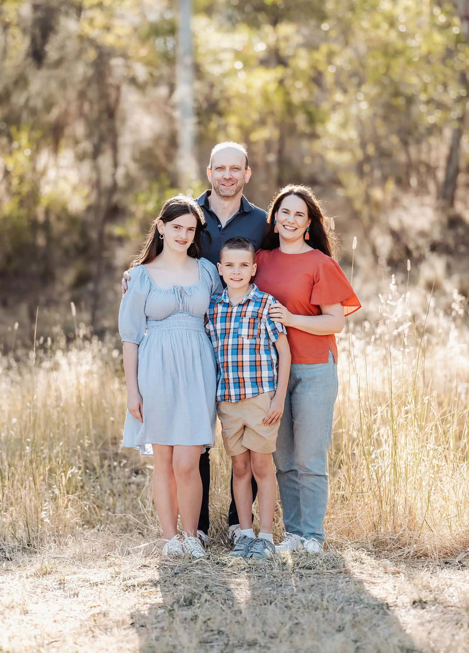 beautiful anstey hill family photoshoot 2 Family enjoying a sunny day outdoors with trees and warm sunlight.