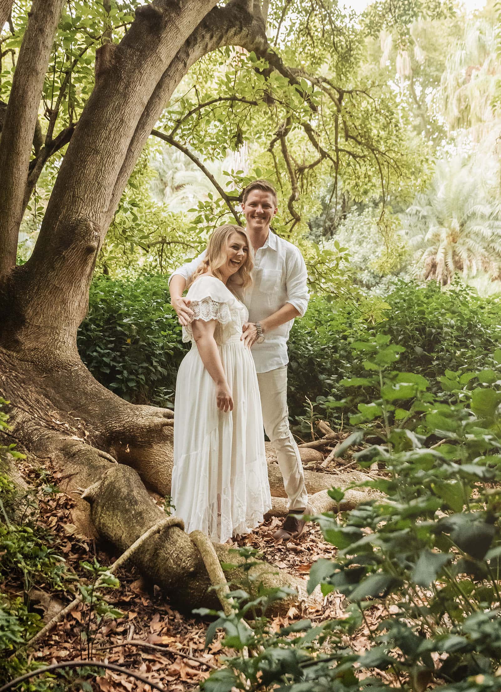 botanic gardens wedding shoot - olivia & sean 4 Couple enjoying a tranquil forest, surrounded by lush greenery and sunlight filtering through trees.