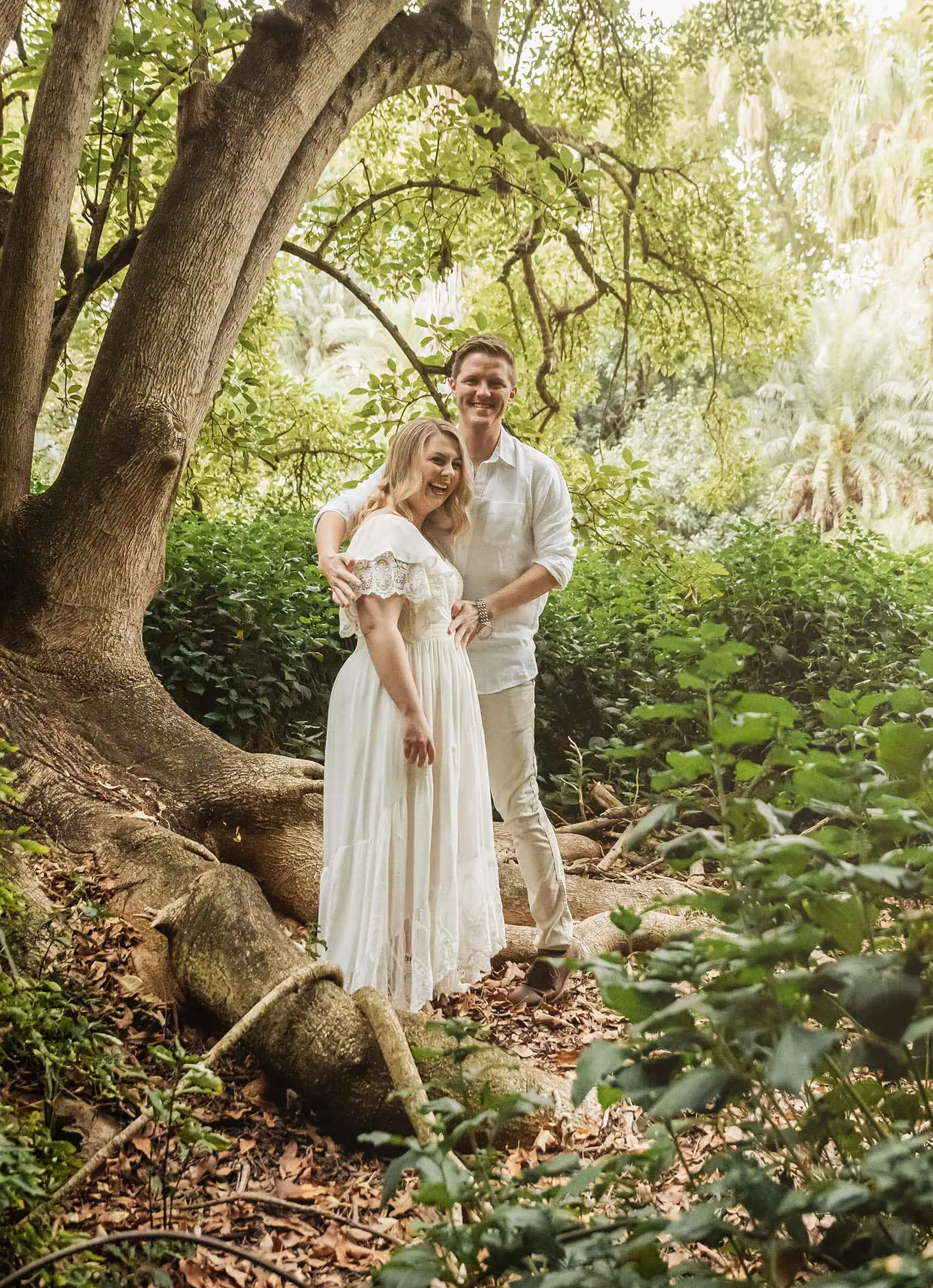 botanic gardens wedding shoot - olivia & sean 4 Couple enjoying a tranquil forest, surrounded by lush greenery and sunlight filtering through trees.