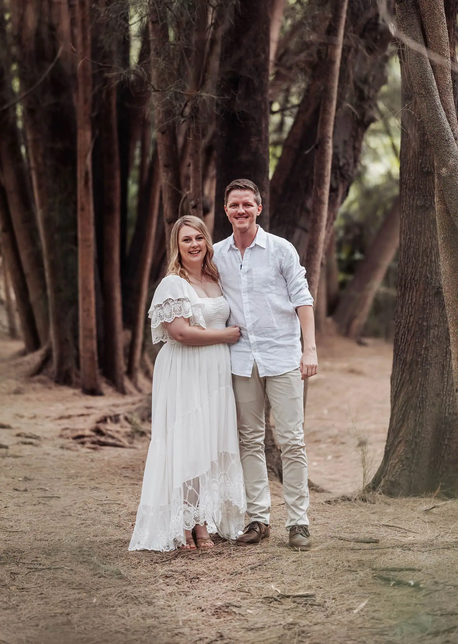 botanic gardens wedding shoot - olivia & sean 16 Happy couple in white attire in a tranquil forest setting.