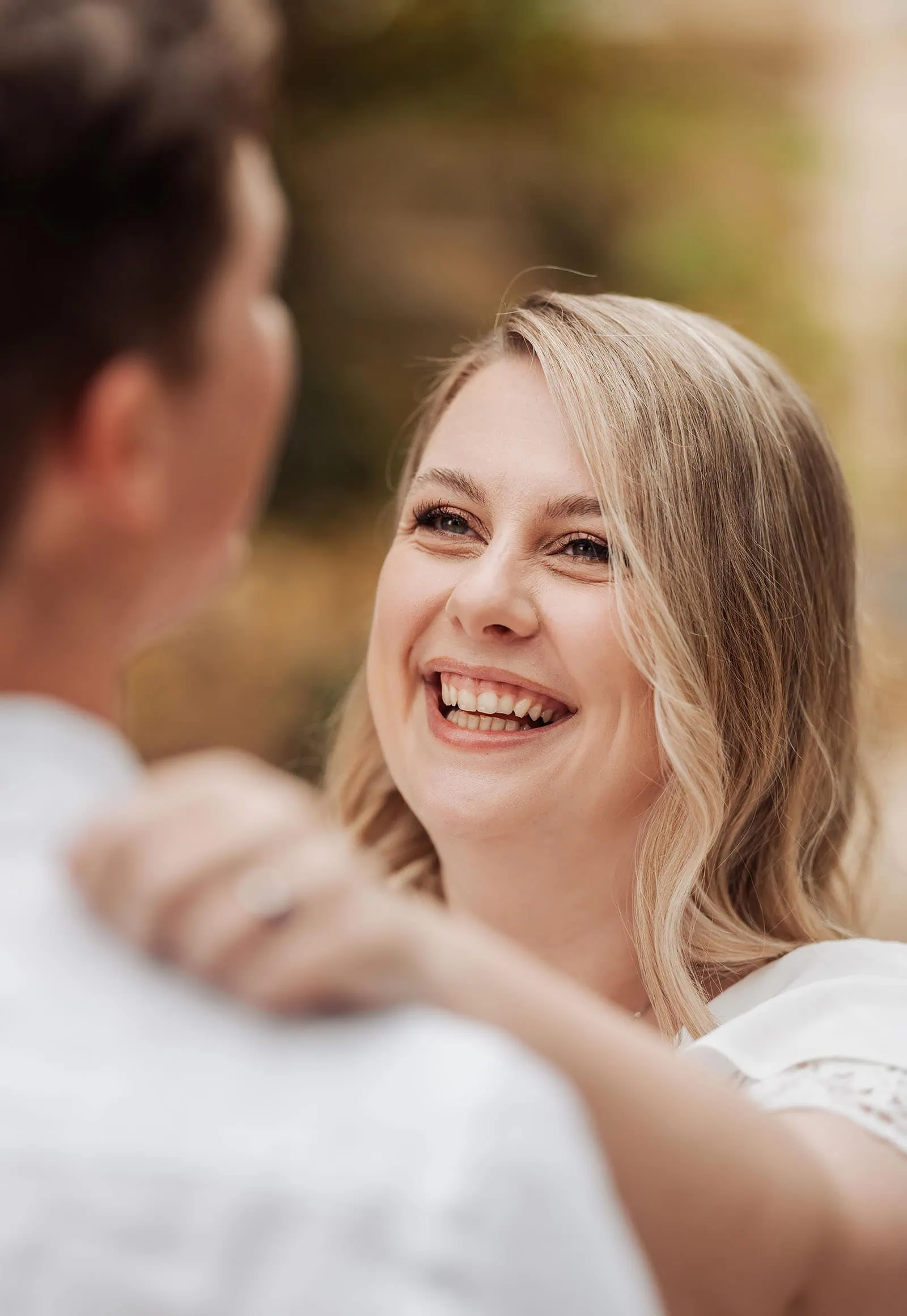 botanic gardens wedding shoot - olivia & sean 10 Woman joyfully smiling outdoors during a warm, intimate moment.