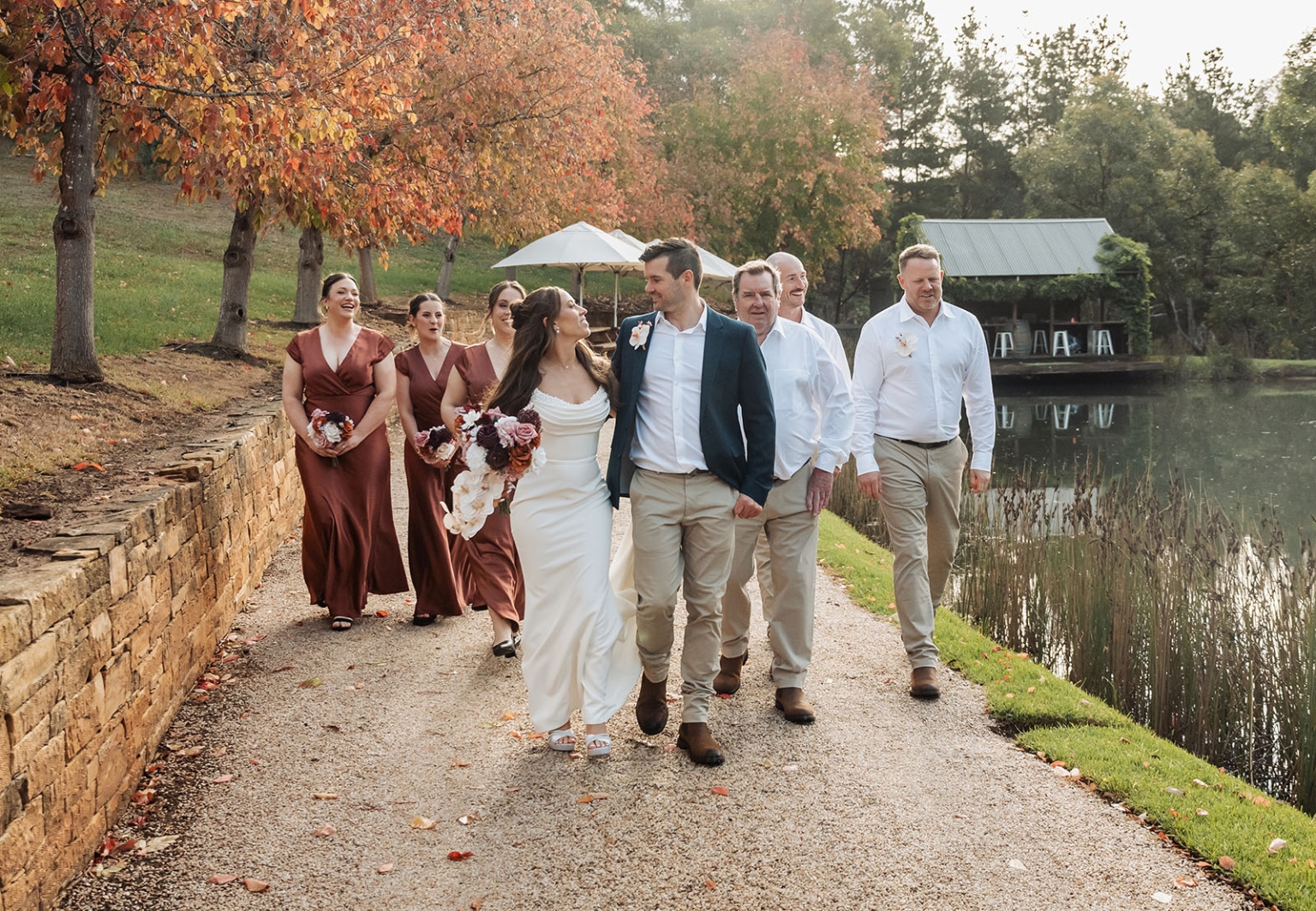 the lane vineyard wedding - caitlyn & craig 116 Elegant autumn wedding with bride, groom, and party, surrounded by vibrant fall foliage.