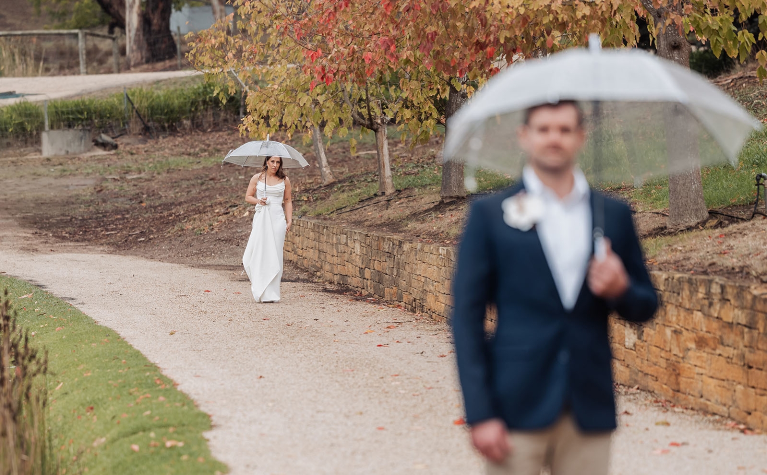 the lane vineyard wedding - caitlyn & craig 100 Bride and groom with umbrellas in autumn park pathway.