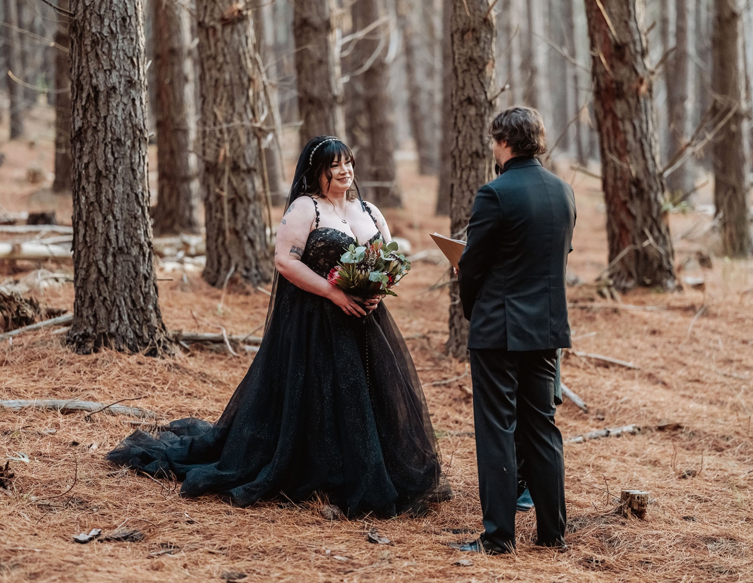 kuitpo forest metal themed wedding – erin & michael 7 Black wedding dress bride in romantic pine forest ceremony.