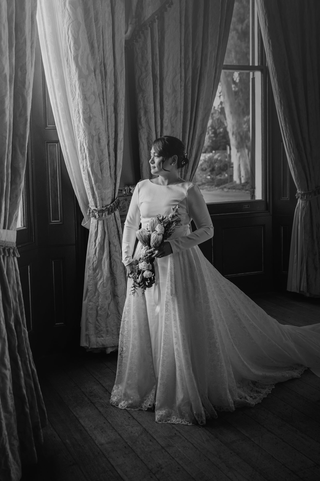 adelaide's st peter's cathedral wedding - irish & nick 43 Black and white bridal portrait by window with elegant wedding bouquet.