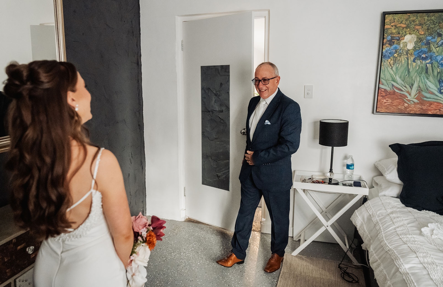 the lane vineyard wedding - caitlyn & craig 96 Bride in white dress shares emotional first look with father in elegant bedroom.