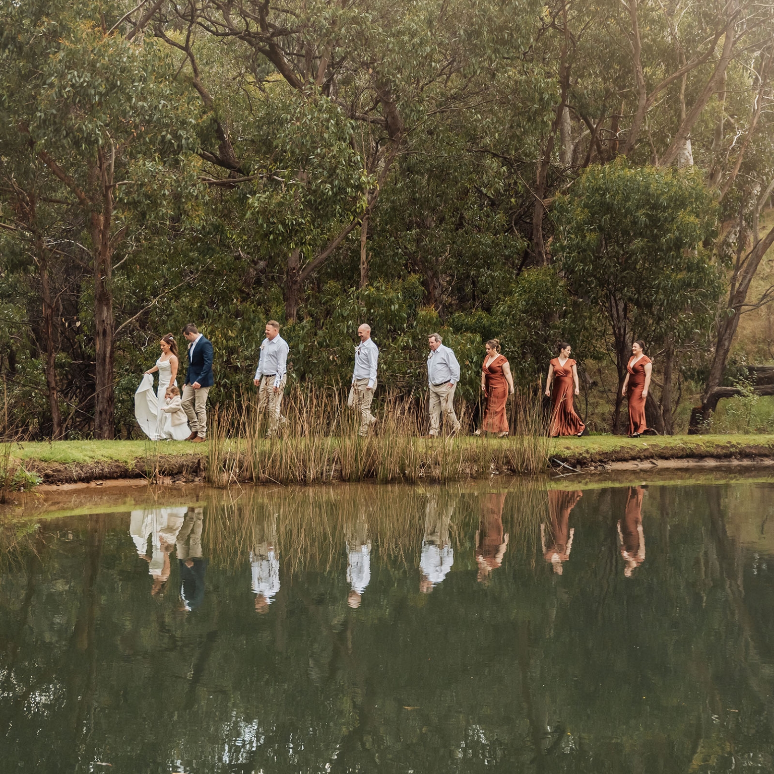 the lane vineyard wedding - caitlyn & craig 108 Bride and groom outdoor procession by a lake with bridesmaids and groomsmen.