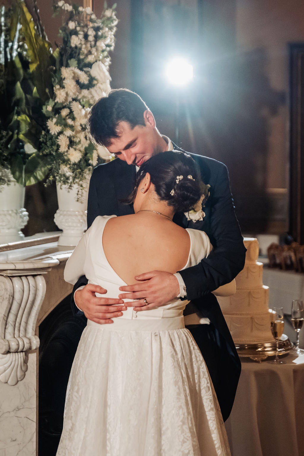 adelaide's st peter's cathedral wedding - irish & nick 62 Bride and groom embrace at elegant indoor wedding reception.