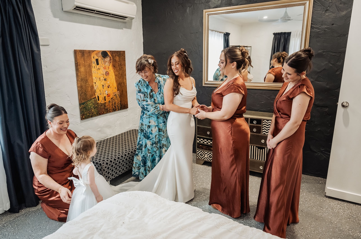 the lane vineyard wedding - caitlyn & craig 88 Bride surrounded by family and bridesmaids in joyful, elegant bridal suite moment.
