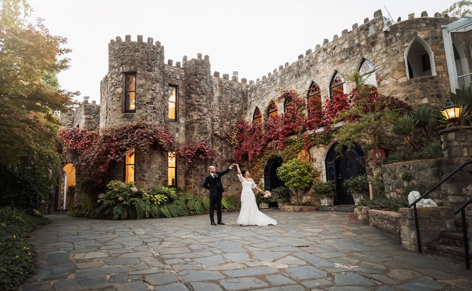 adelaide hills wedding at the manor - jo & dan 57 Bride and groom dancing in romantic castle courtyard wedding venue.