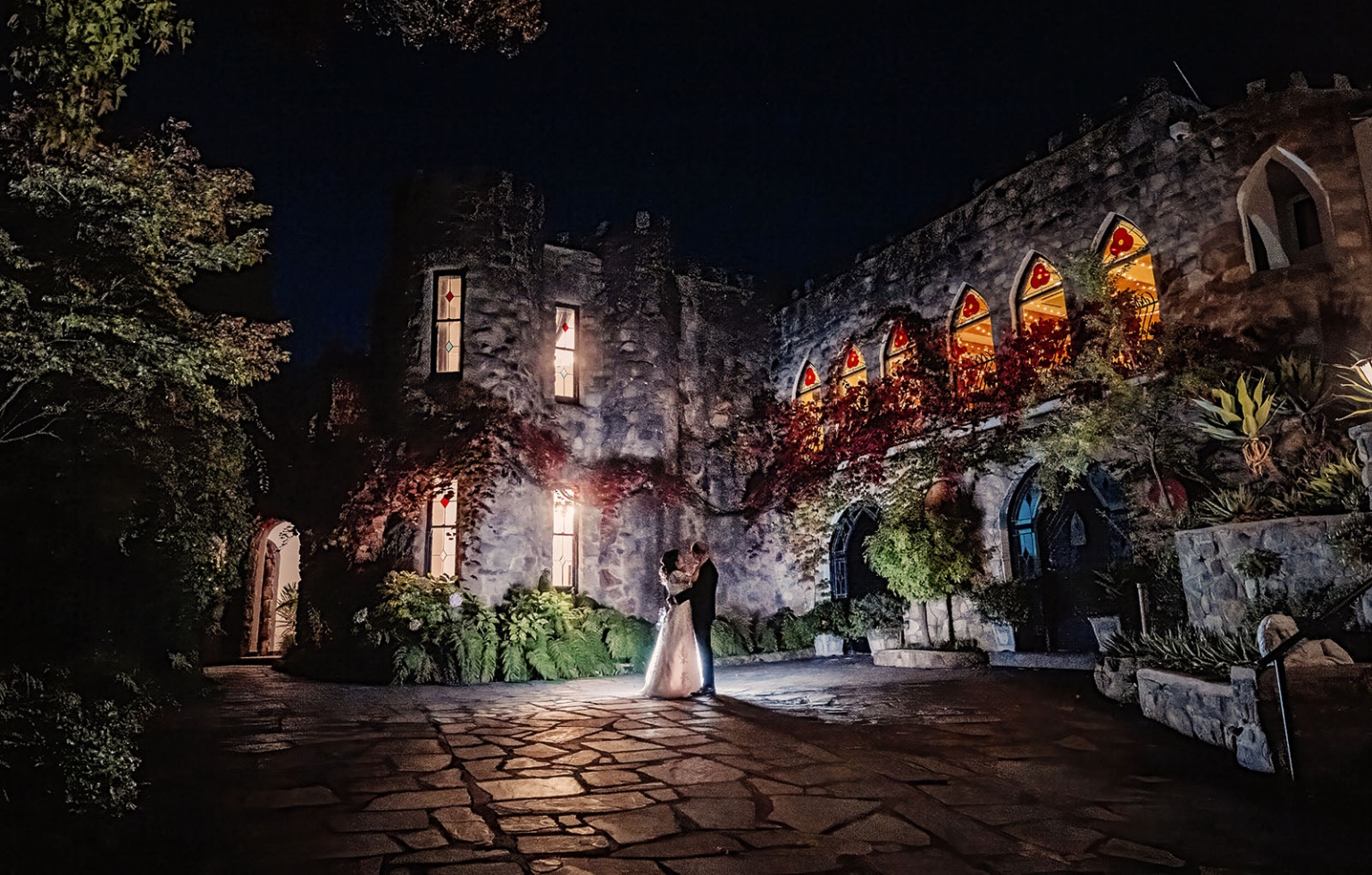 adelaide hills wedding at the manor - jo & dan 75 Nighttime castle courtyard wedding portrait of bride and groom.