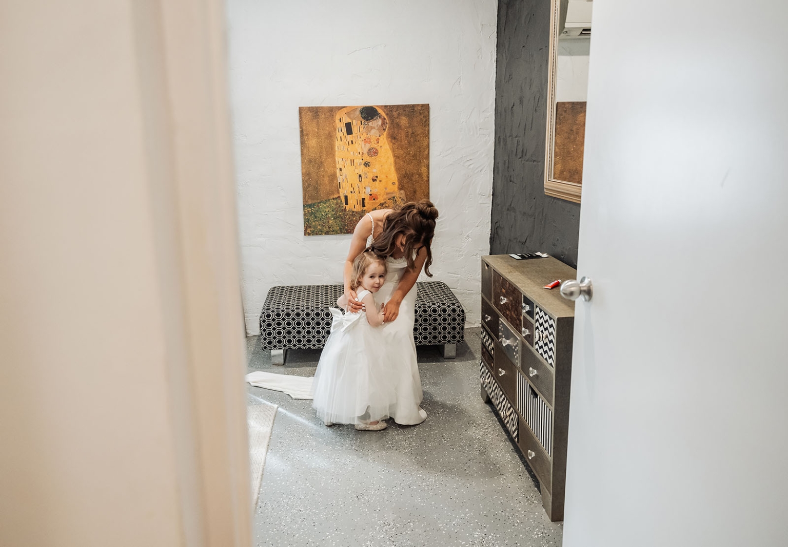 the lane vineyard wedding - caitlyn & craig 87 Bride and girl in dressing room sharing tender moment on wedding day.