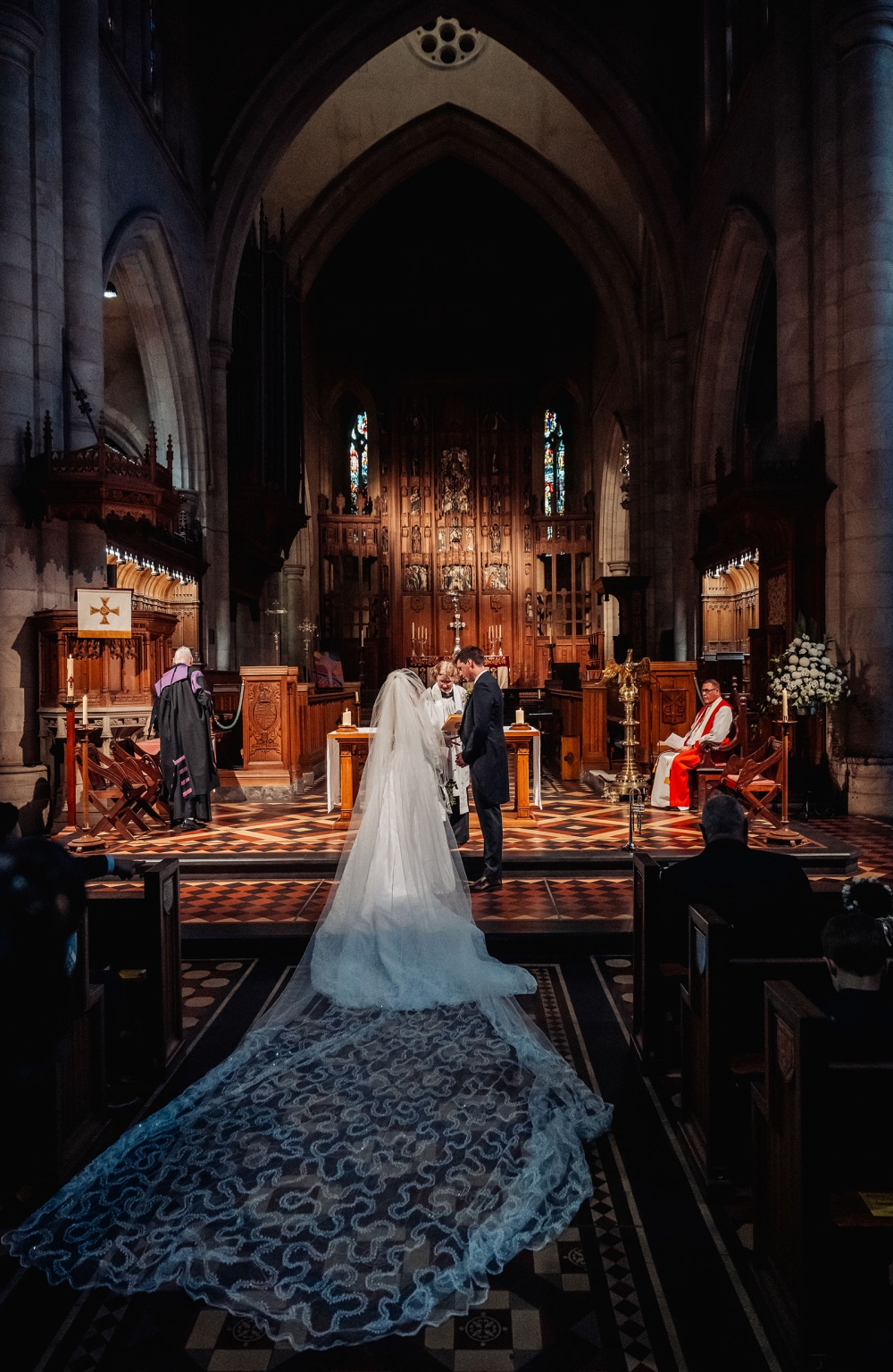 adelaide's st peter's cathedral wedding - irish & nick 16 Gothic church wedding ceremony with brides lace train at cathedral altar.