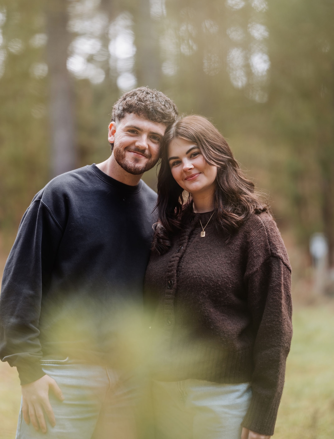 cabn at kuitpo forest proposal - tamsyn & blake 20 Couple enjoying a serene, intimate moment in nature, dressed casually, with a warm glow.