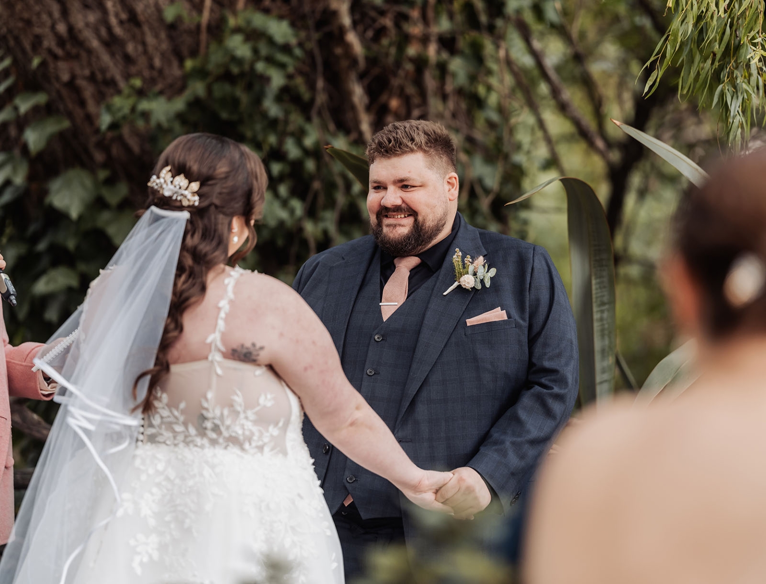 comida wedding - georgia & james 14 Bride and groom outdoor wedding ceremony with floral lace dress and dark suit.