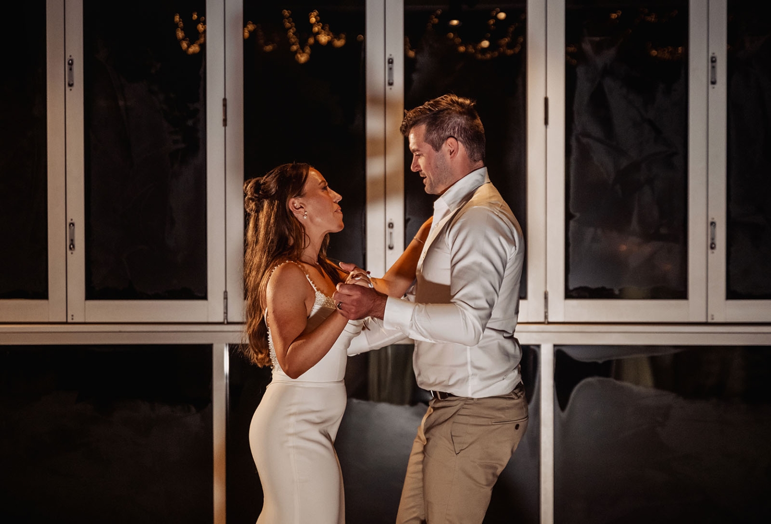 the lane vineyard wedding - caitlyn & craig 136 Couple dancing intimately at a wedding, wearing elegant formal attire, with romantic ambiance.