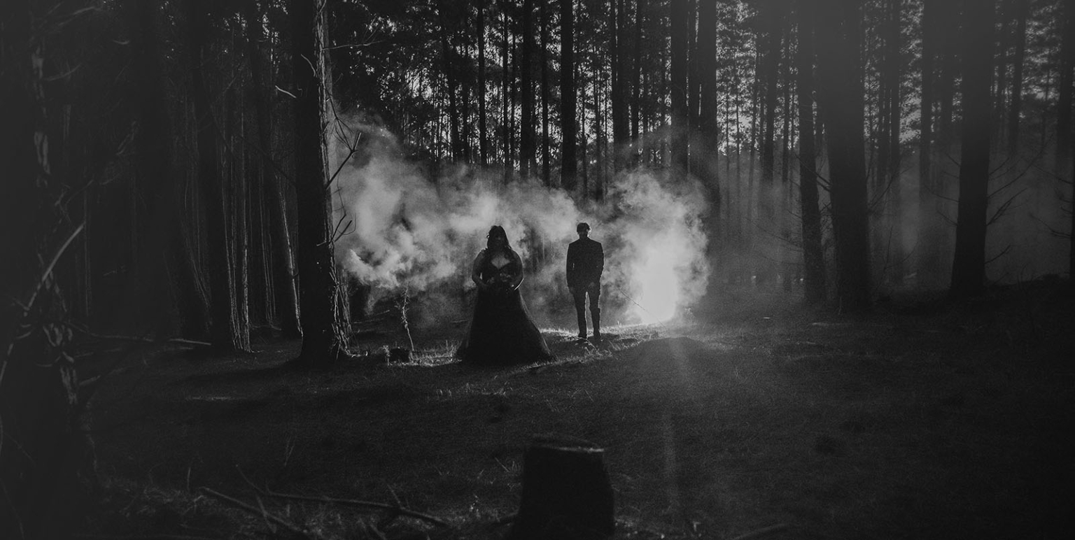 kuitpo forest metal themed wedding – erin & michael 29 Gothic formal portrait in a smoky dark forest with eerie silhouetted couple.