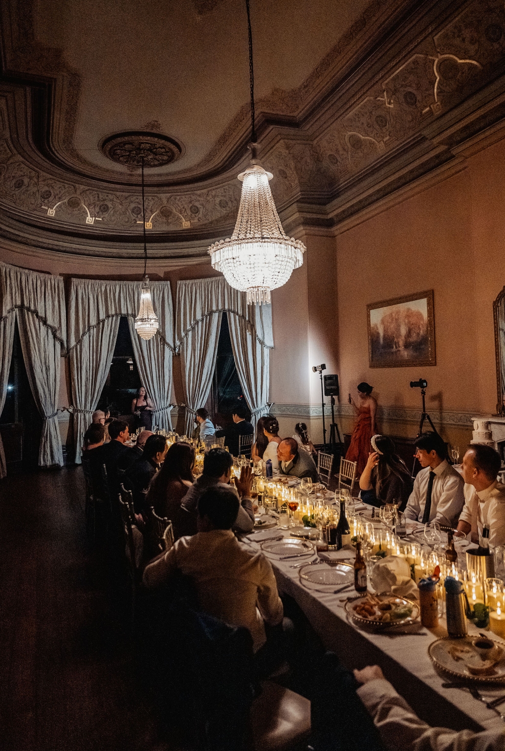 adelaide's st peter's cathedral wedding - irish & nick 57 Elegant wedding banquet in historic ballroom with chandeliers and candlelit dinner guests.