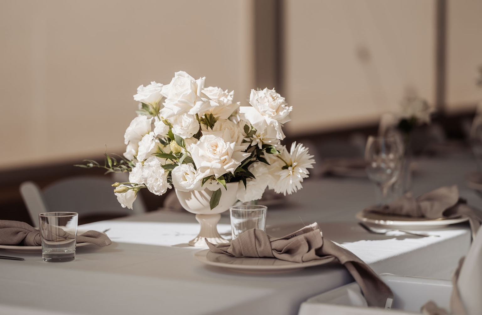 lloyd brothers wedding - dajana & tom 2 Elegantly set dining table with white roses and stylish place settings.