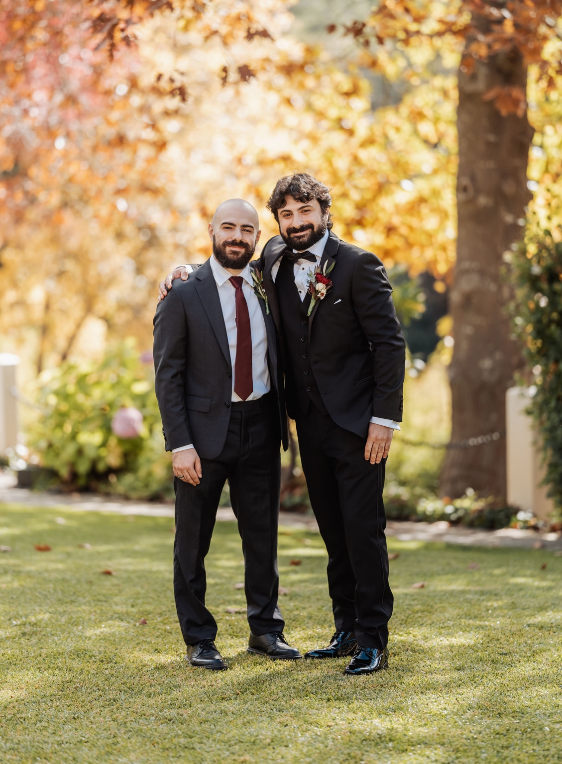 beautiful manor basket range wedding - sophie & theodore 86 Two men in formal suits at a picturesque autumn wedding.
