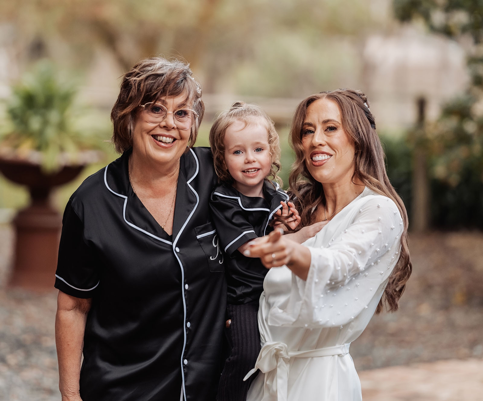 the lane vineyard wedding - caitlyn & craig 84 Joyful family moment with three generations at a garden celebration.