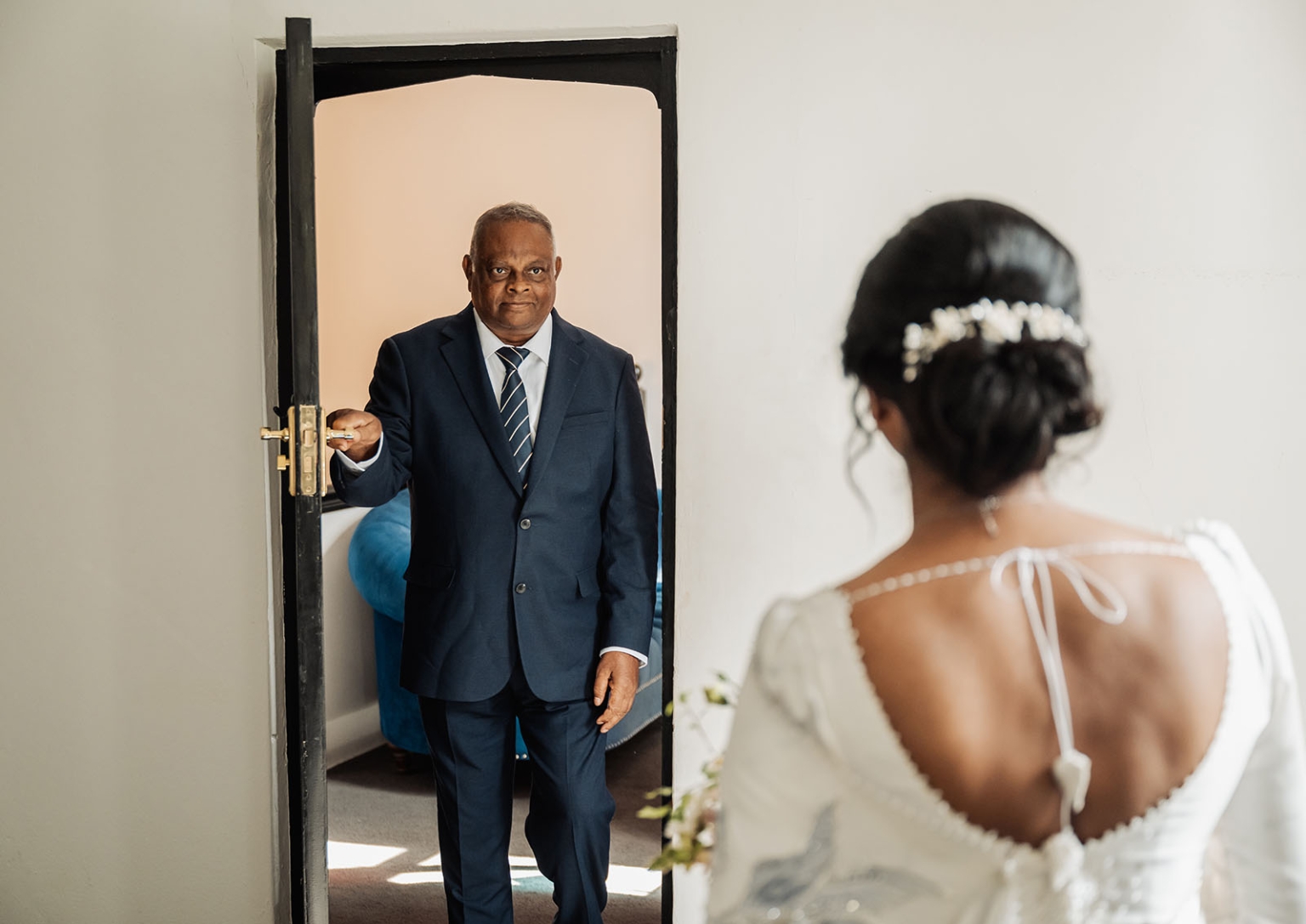 manor wedding in basket range - methmini & aravinda 120 Bride and father share emotional moment at wedding, brides elegant gown and updo highlighted.