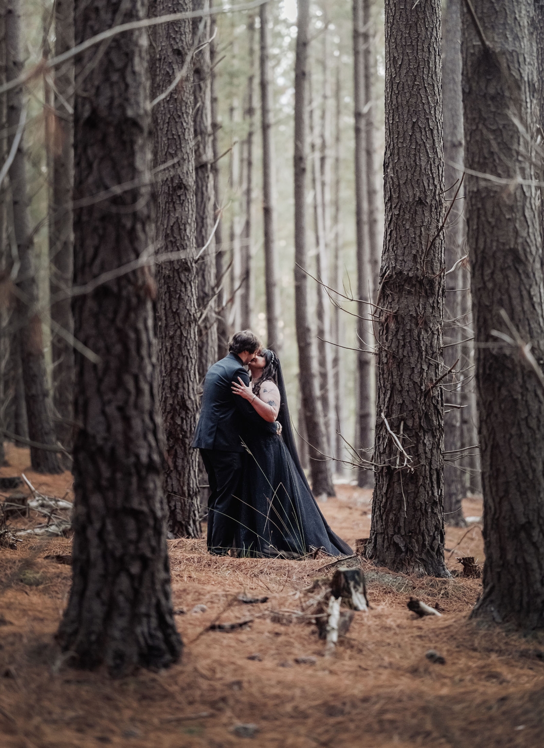 kuitpo forest metal themed wedding – erin & michael 18 Gothic wedding couple kissing in a secluded pine forest.