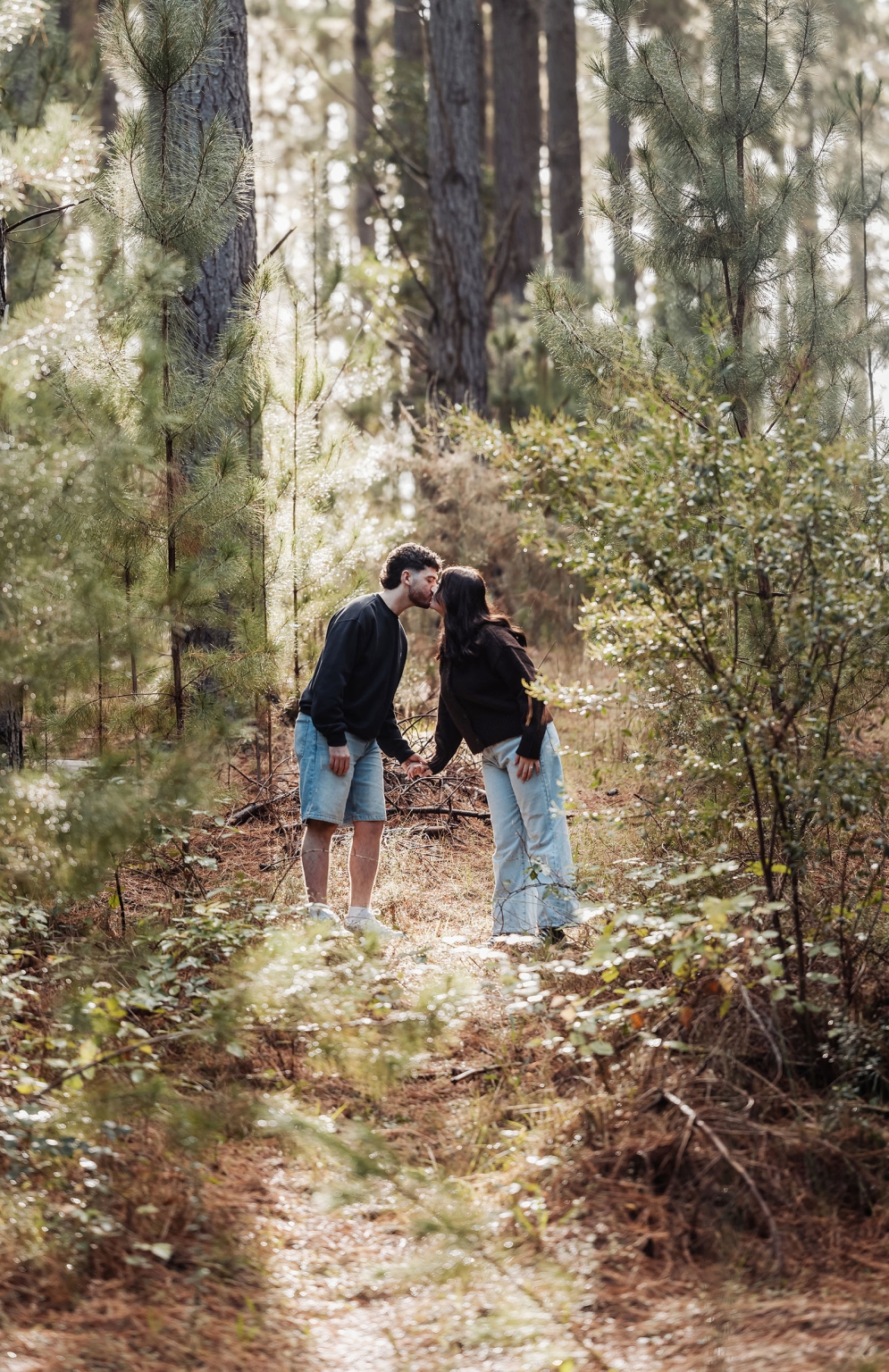 cabn at kuitpo forest proposal - tamsyn & blake 28 Couple sharing a tender moment in a serene, sunlit forest path.