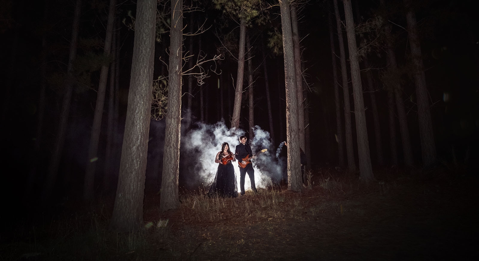 kuitpo forest metal themed wedding – erin & michael 42 Violinist and guitarist performing in a smoky dark forest at night.