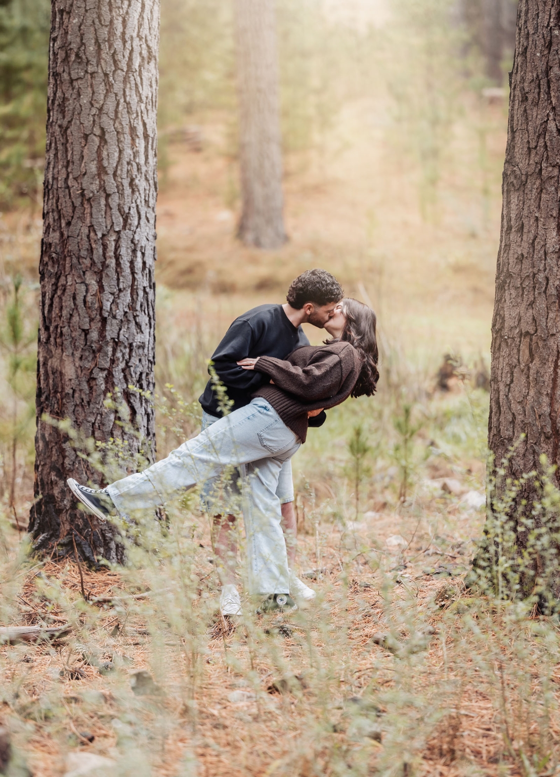 cabn at kuitpo forest proposal - tamsyn & blake 14 Couple kissing in forest surrounded by trees under golden light.