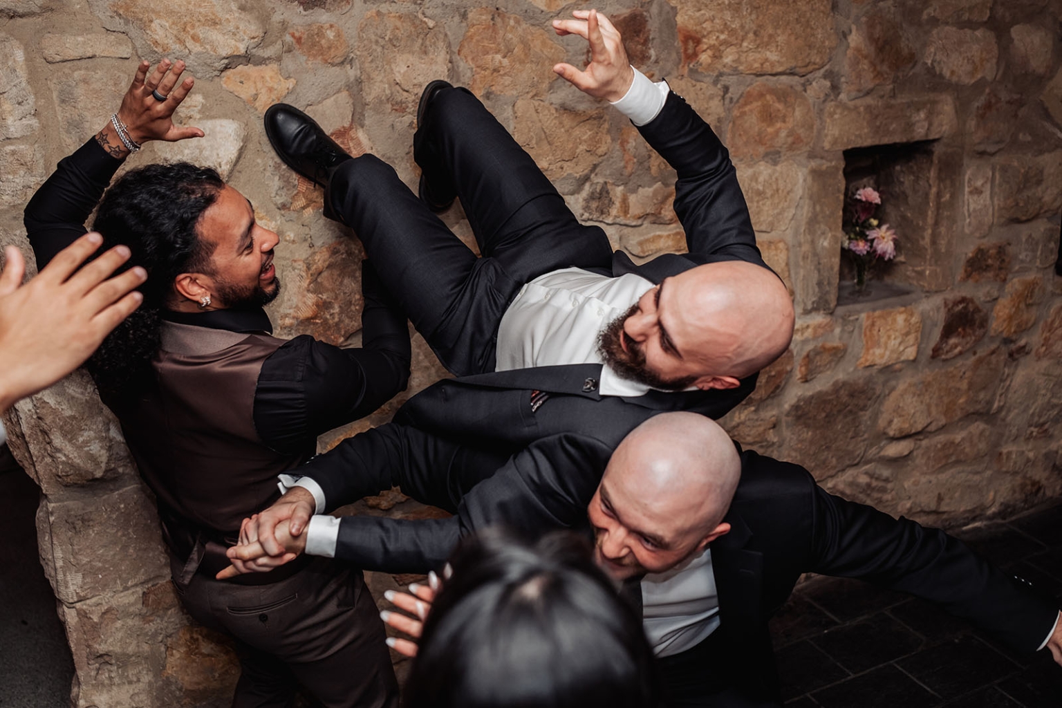 beautiful manor basket range wedding - sophie & theodore 146 Groomsmen dancing joyfully in suits at rustic stone wedding reception.